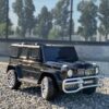 Дитячий двомісний повнопривідний електромобіль Bambi Mercedes AMG G63 (MP3) з ручкою для транспортування та автофарбуванням, чорний