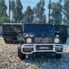 Дитячий двомісний повнопривідний електромобіль Bambi Mercedes AMG G63 (MP3) з ручкою для транспортування та автофарбуванням, чорний