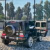 Дитячий двомісний повнопривідний електромобіль Bambi Mercedes AMG G63 (MP3) з ручкою для транспортування та автофарбуванням, чорний