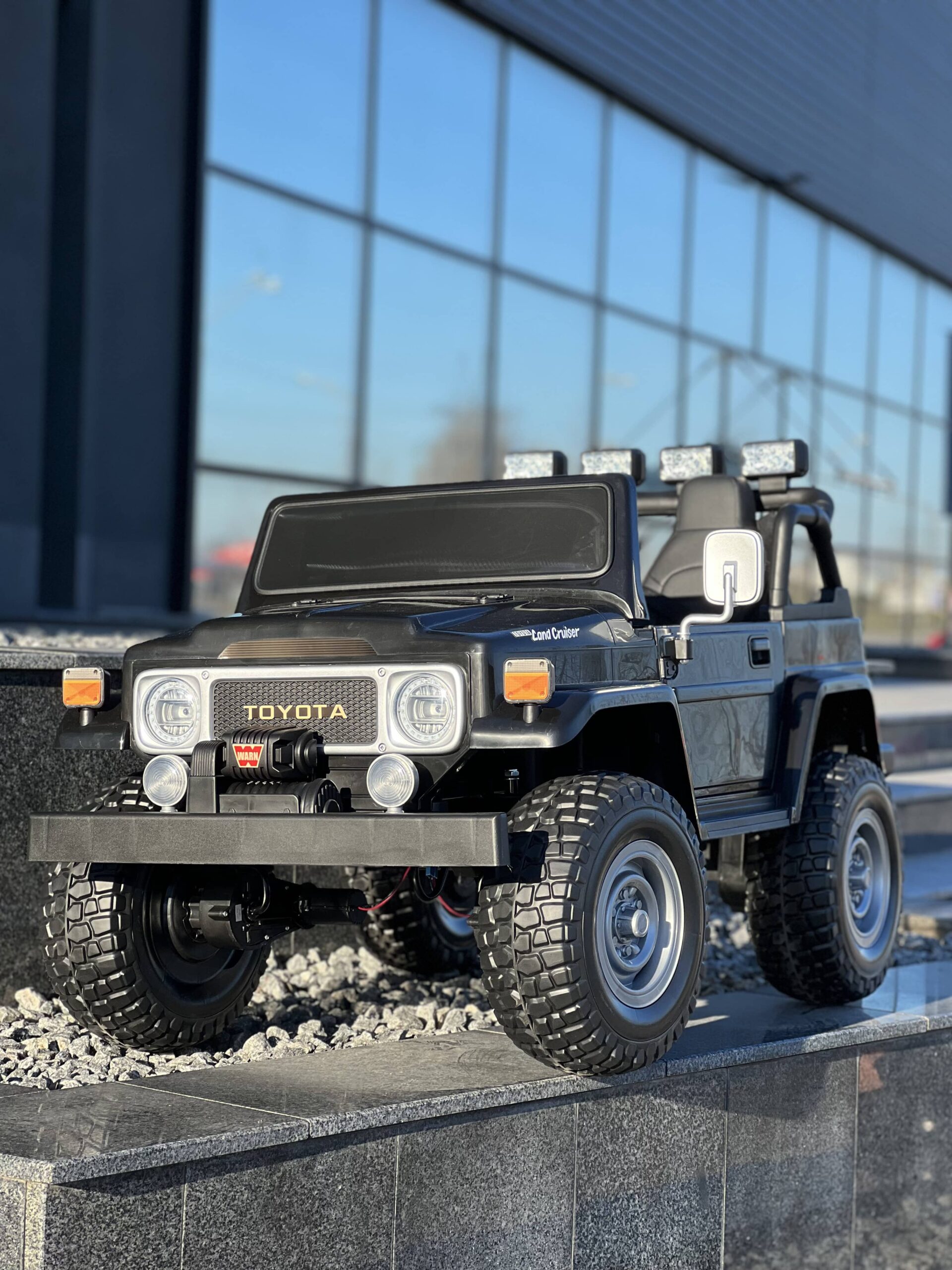 Детский двухместный полноприводный электромобиль Bambi Toyota Land Cruiser (MP3) с ручкой для транспортировки и багажником, черный